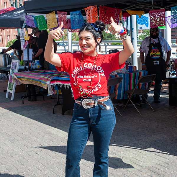 A smiling woman wearing a red 'Chili Cookoff'