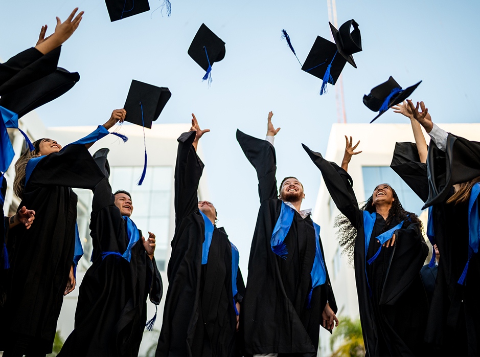 Gradating Students throwing caps in the air