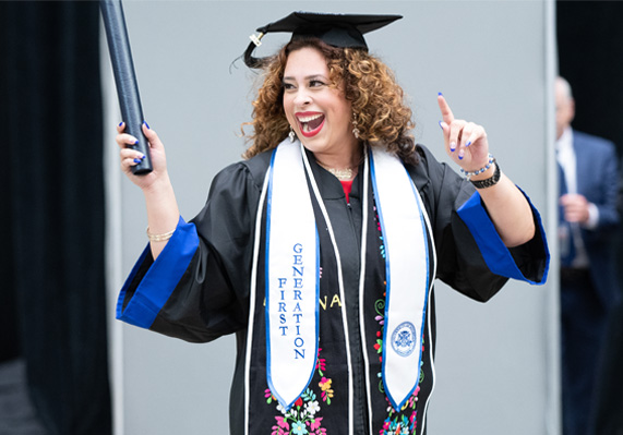 Student holding diploma at commencement