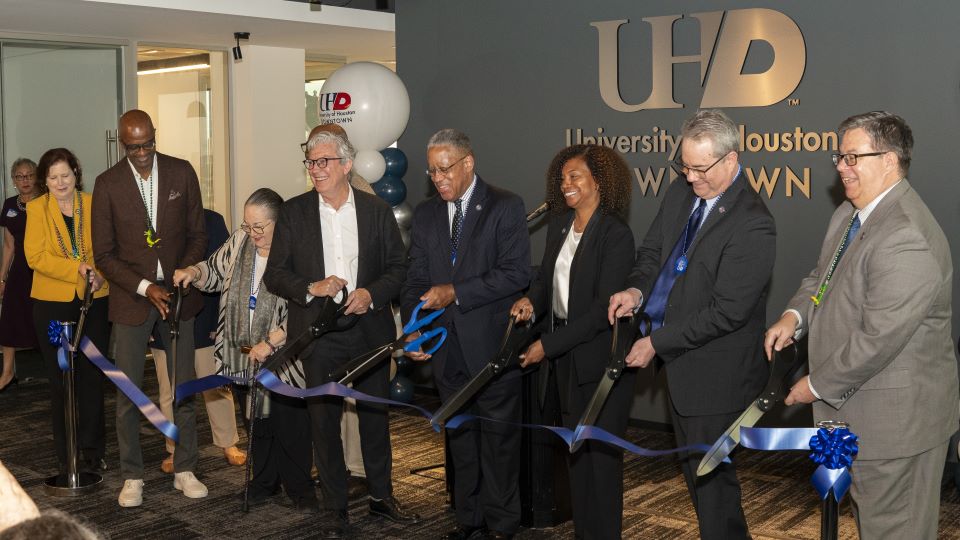 UHD President and others cutting the ribbon at1801 Main