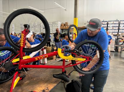 UHD volunteers work on a bicycle