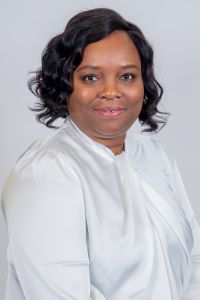 Christina Adesina wears a white silk shirt