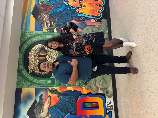 Bobby and Brenda Ramos pose for a photo in front of their mural.