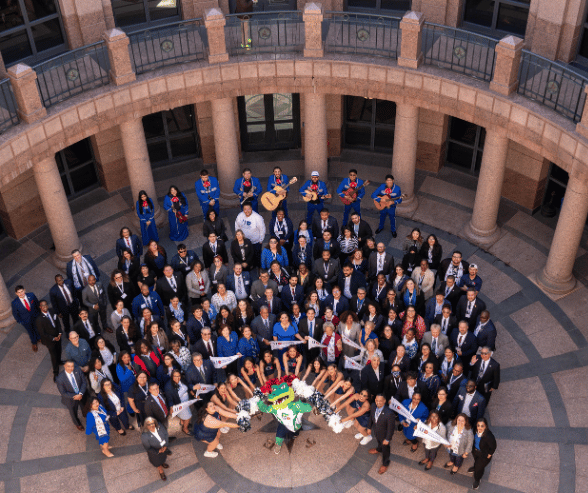 UHD President Loren J. Blanchard, UHD staff, faculty, alum, students and Ed-U-Gator smile in the rotunda of the state capitol 