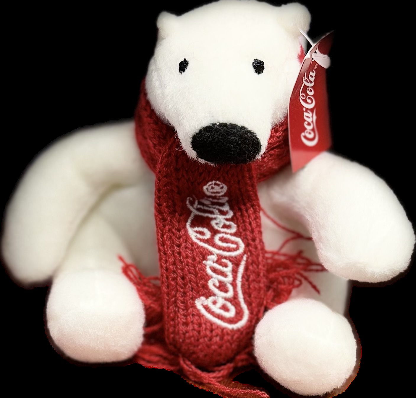 Stuffed polar bear with a Coca-Cola scarf