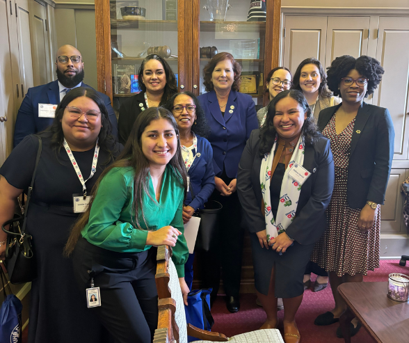 University of Houston-Downtown alumni and students, alongside UHD Provost Deborah E. Bordelon PhD smile in a state legislator's chambers 