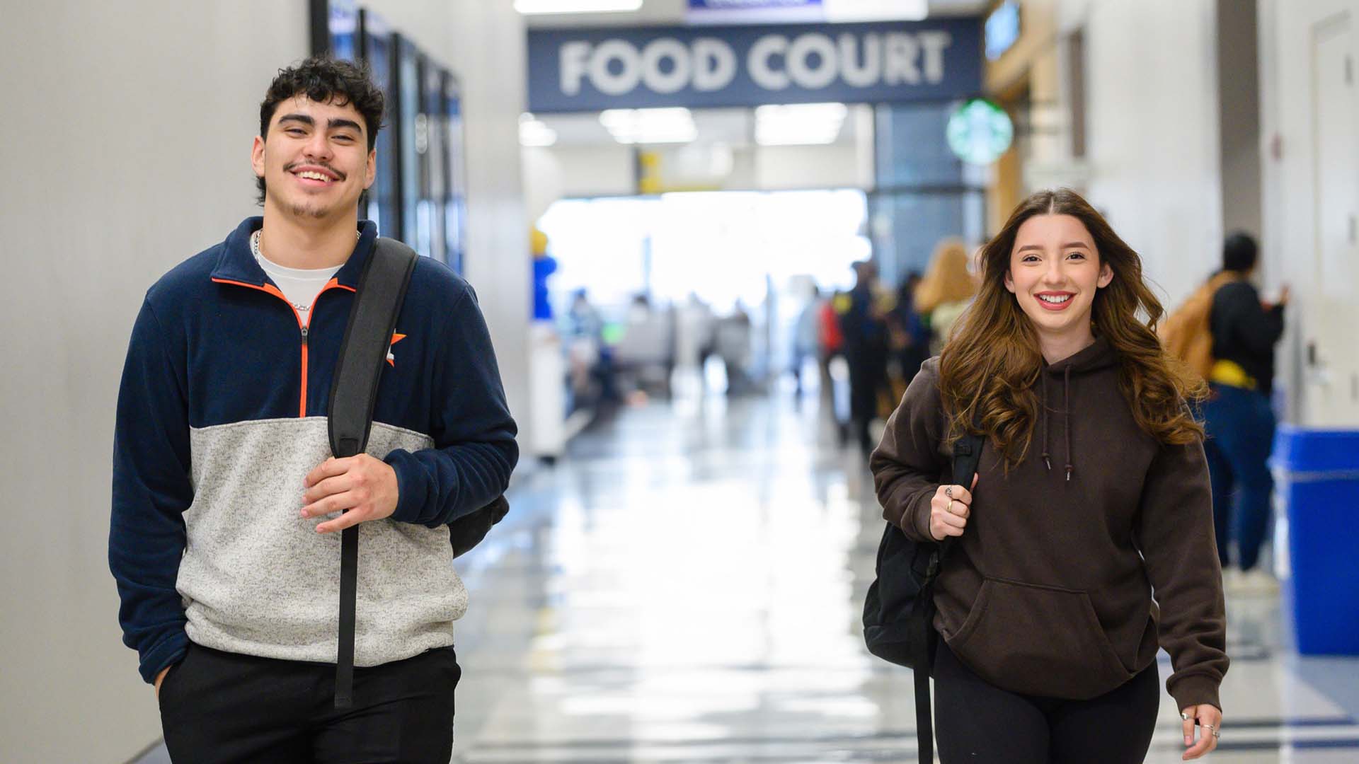 Two students walking through the hallway