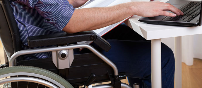 student in wheelchair using computer