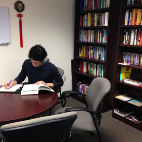 Student at table studying.