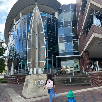 A student walking up to University of Houston-Downtown's College of Public Service in Downtown Houston 