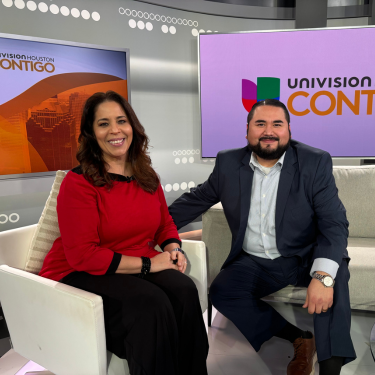 The University of Houston-Downtown Registrar Ovidio Galvan smiles aside Grace Olivares host of Univision Houston's Contigo en la Comunidad  