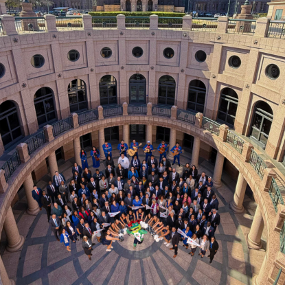 University of Houston-Downtown staff, faculty, students, and alumni stand and smile in the rotunda of the Texas Capitol at UHD Day at the Capitol on Wednesday, Feb. 26, 2025.